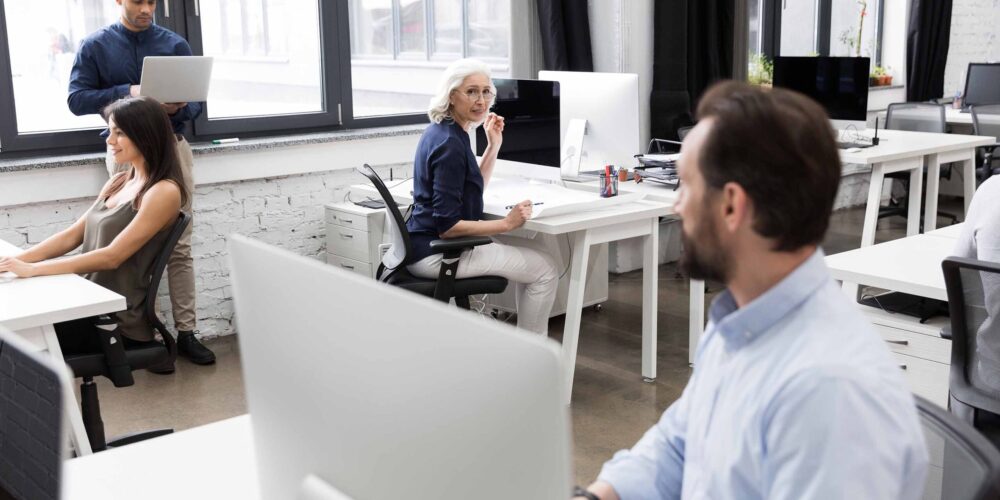 group-business-people-talking-each-other-while-working
